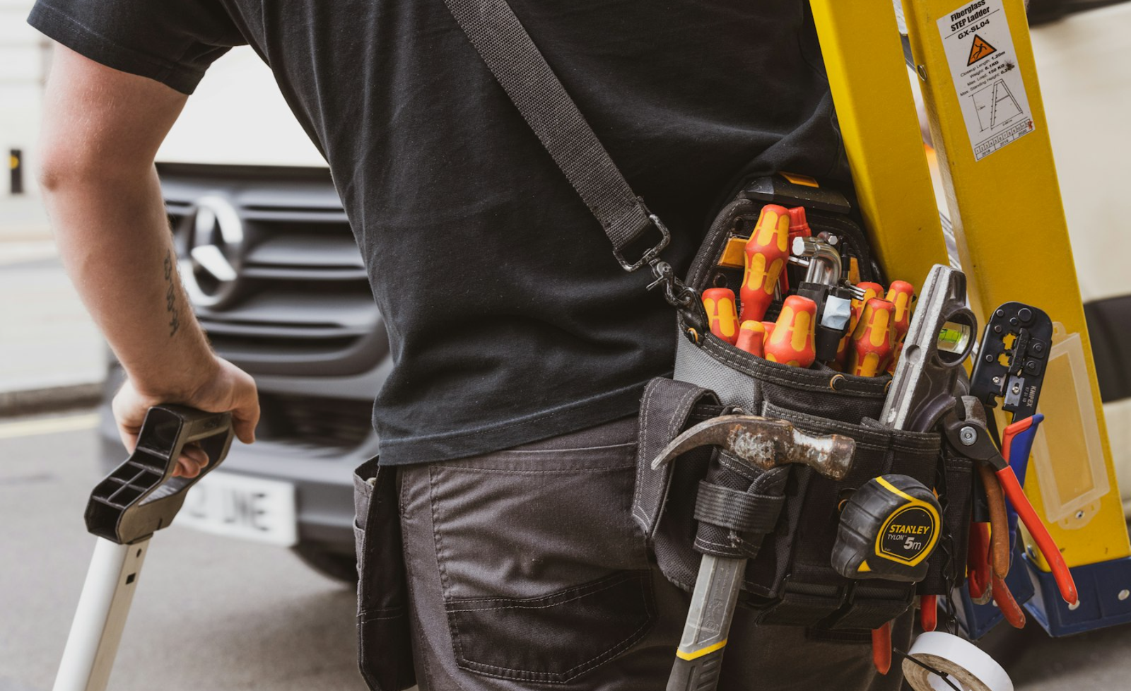 Technician arriving with a tool belt for a same-day repair call